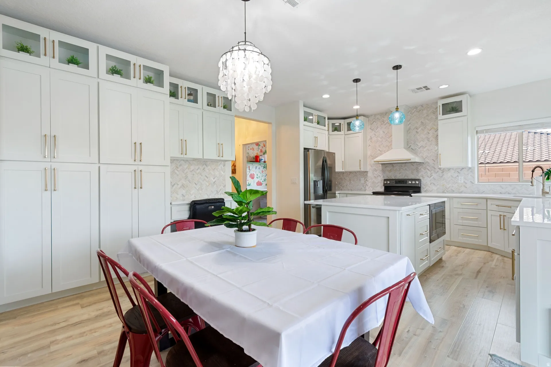 Dining area featuring light wood-type flooring and a chandelier