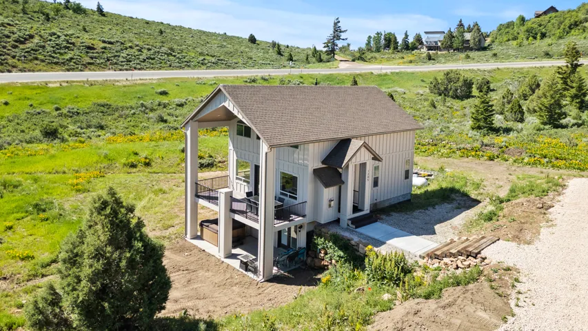 View of side of property featuring a shingled roof and board and batten siding