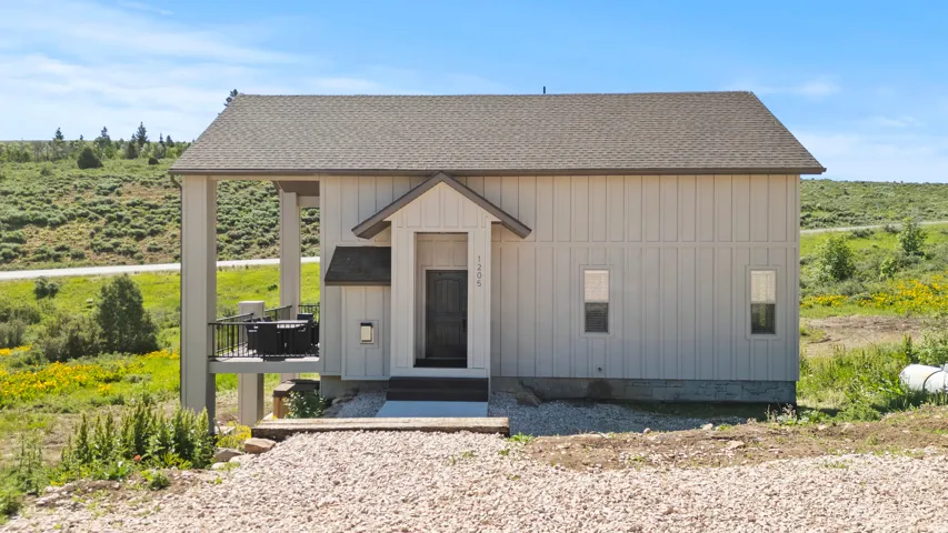 View of front of house featuring roof with shingles
