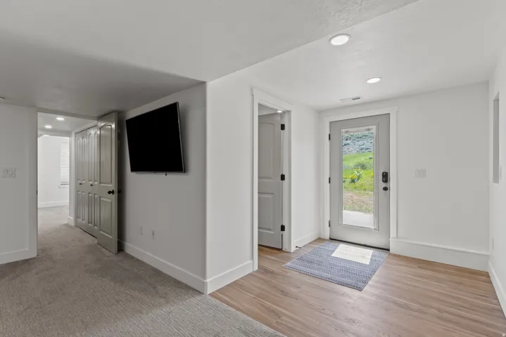 Foyer with recessed lighting and light wood-style floors