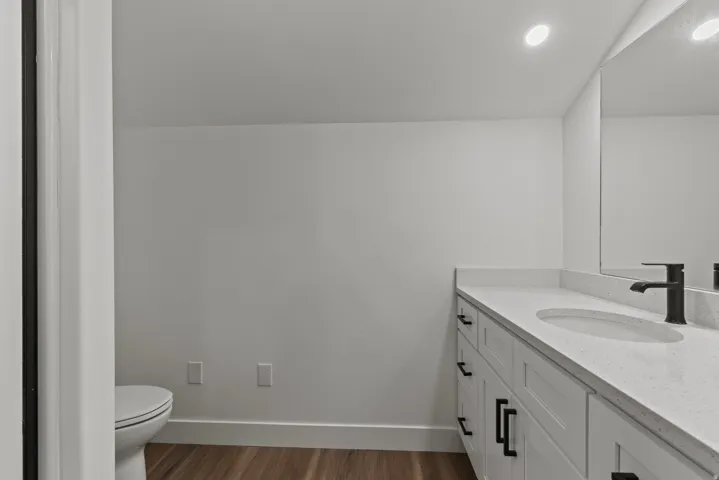 Bathroom featuring vanity and dark wood finished floors