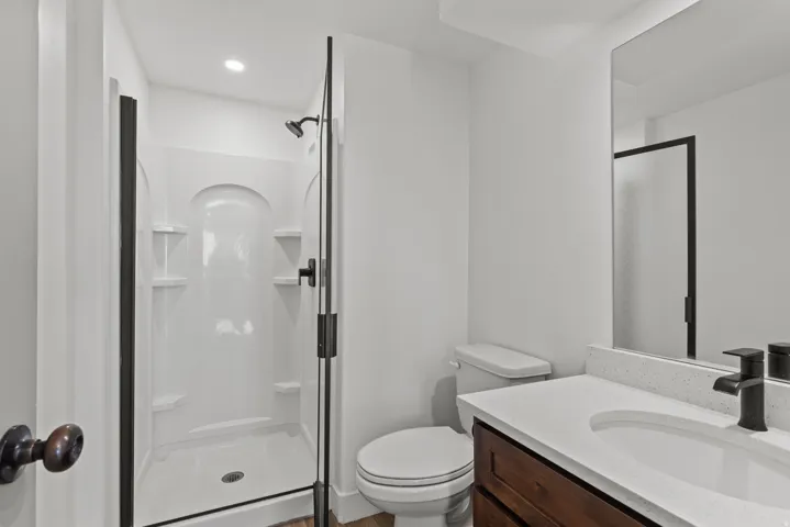 Bathroom with a shower stall and vanity