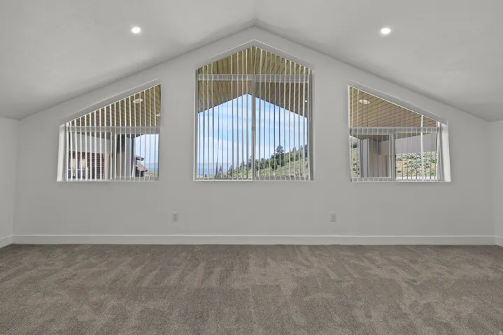 Carpeted spare room with recessed lighting
