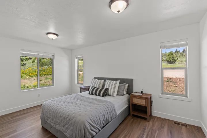 Bedroom with dark wood-type flooring and a textured ceiling