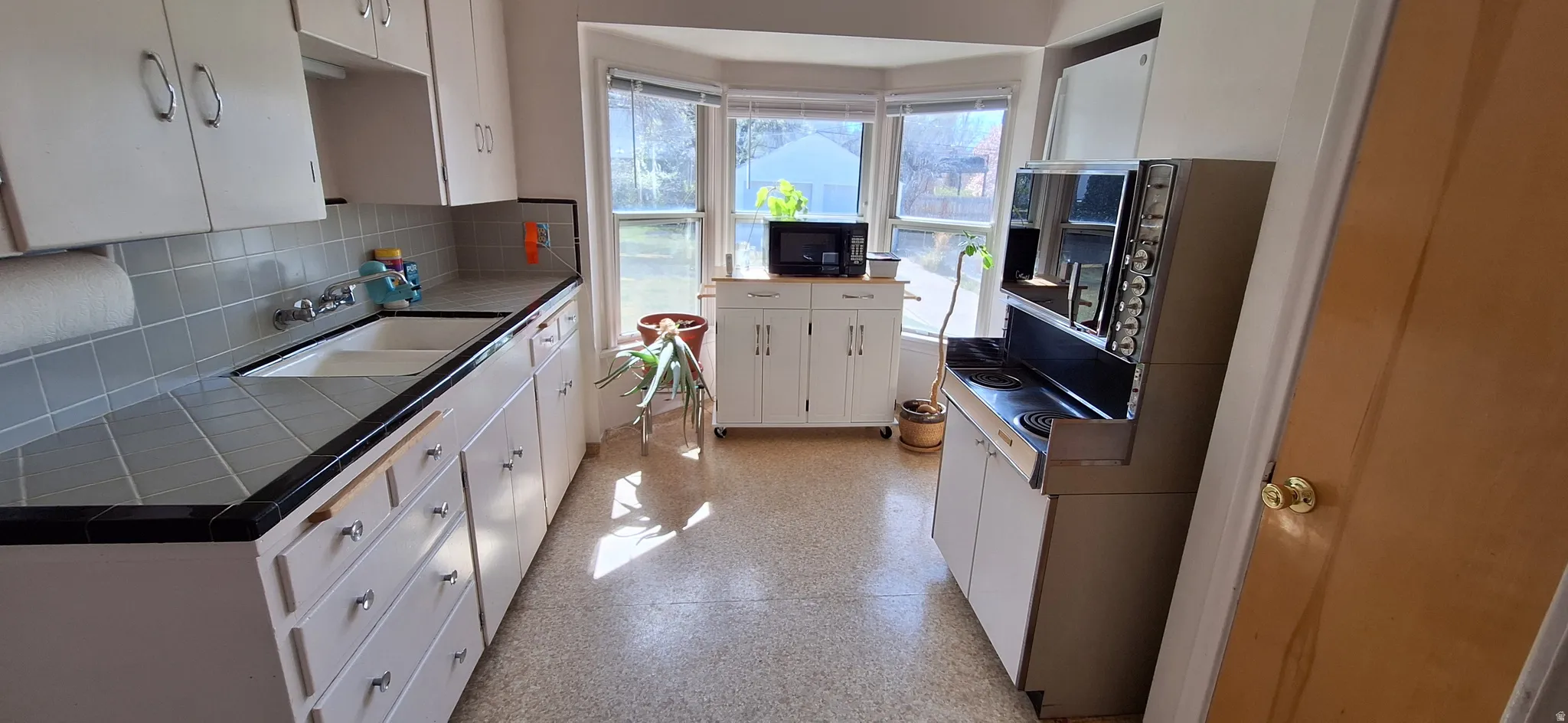 Kitchen showing bay window to back yard