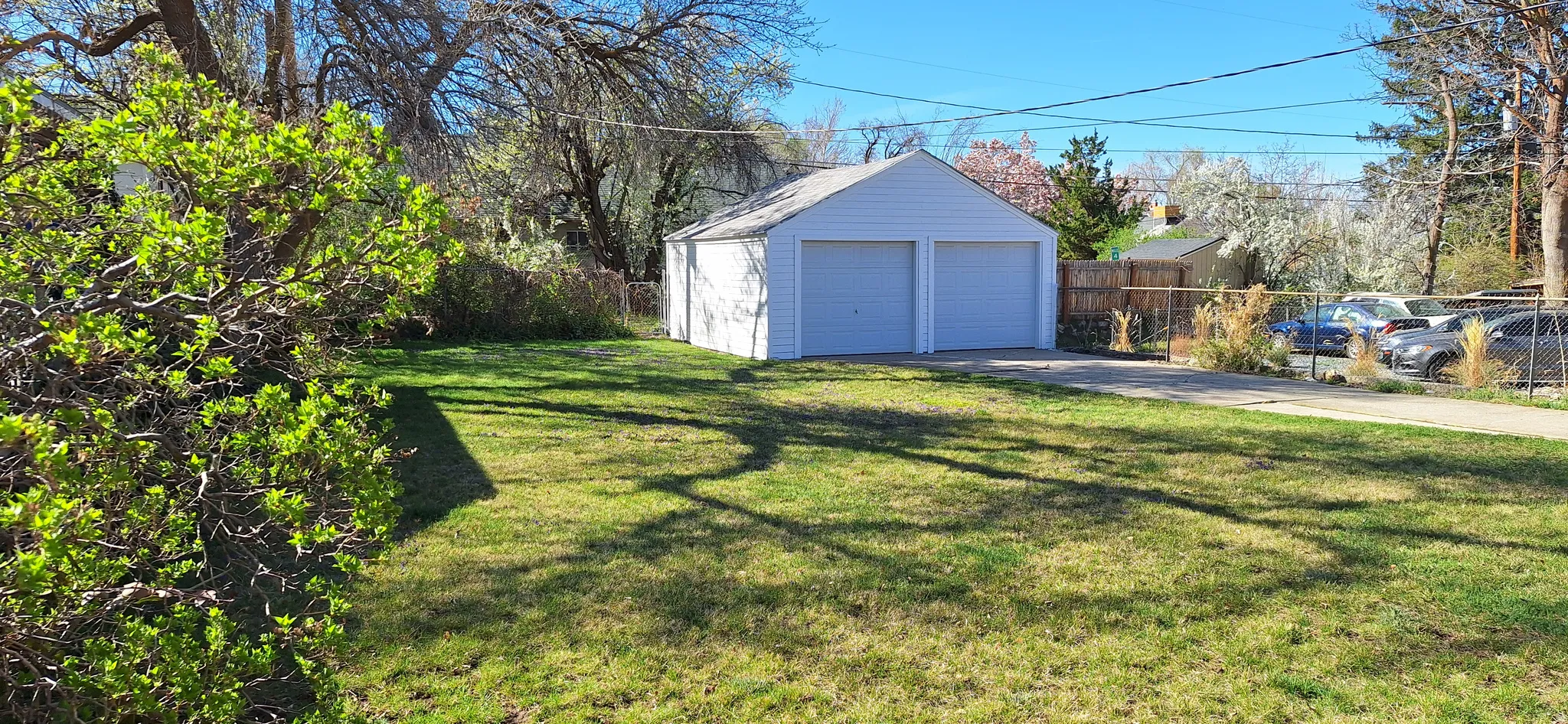 Back yard is fully fenced with dog run behind garage