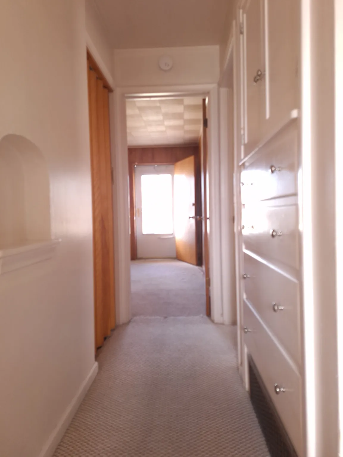 Hallway view from bathroom to front door