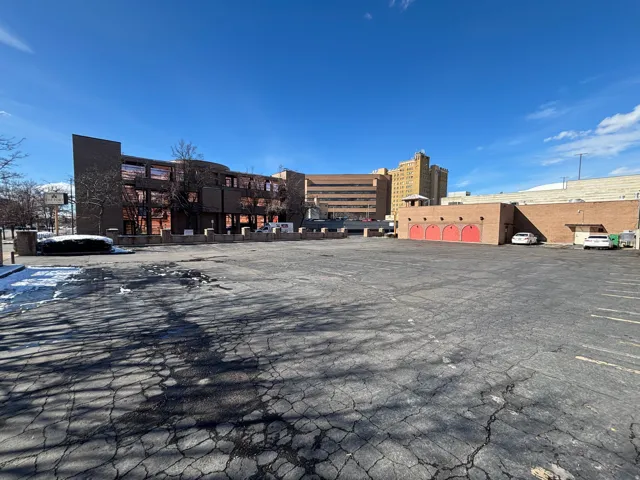 View of commercial property with uncovered parking