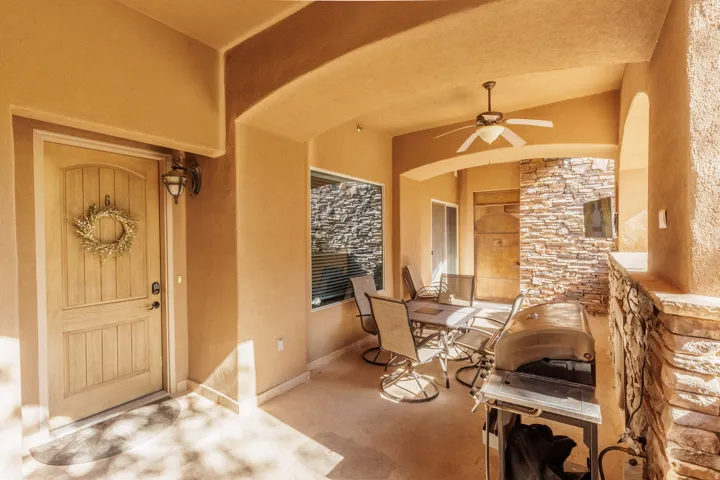 Doorway to property featuring ceiling fan