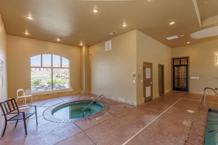 View of indoor hot tub and a sunroom