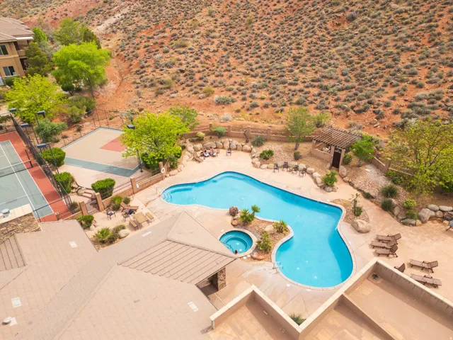 Community pool featuring a patio area, a pickle ball, a hot tub, and a desert view