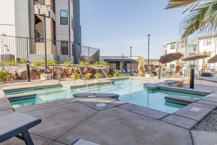 Community pool featuring a hot tub and a patio area