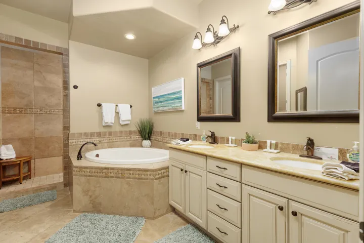 Primary bathroom with double vanity and a garden tub