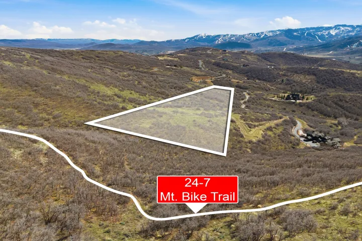 Expansive mountainous landscape with a delineated property boundary and visible mountain ranges