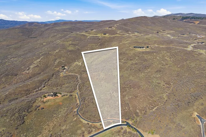 Expansive land parcel with surrounding mountainous terrain