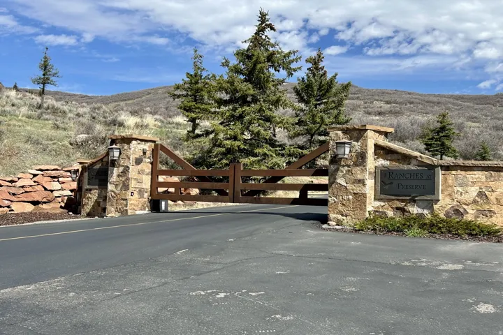 Stone and wood gate entrance with attached lighting