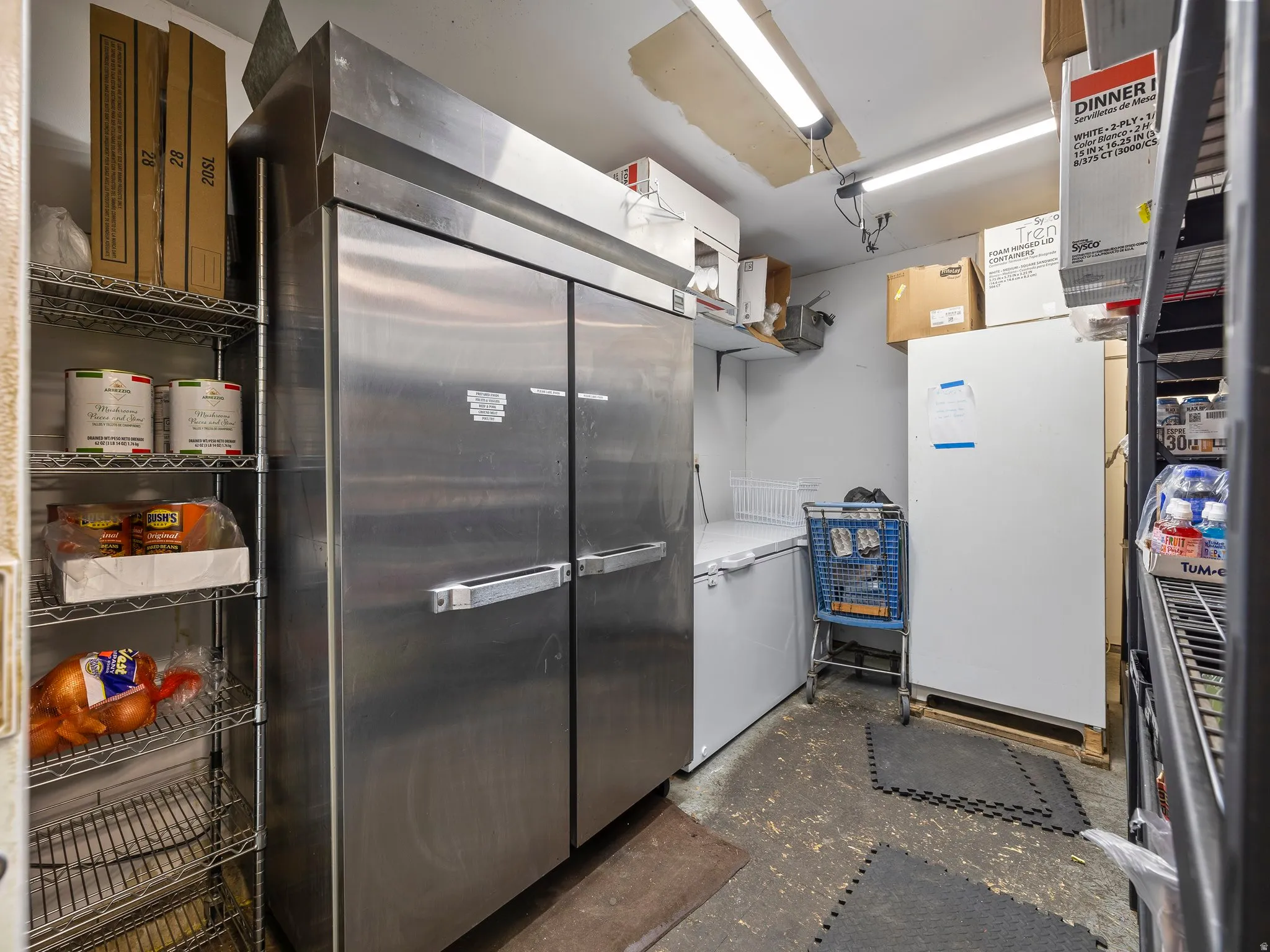 Kitchen featuring high end fridge and white refrigerator