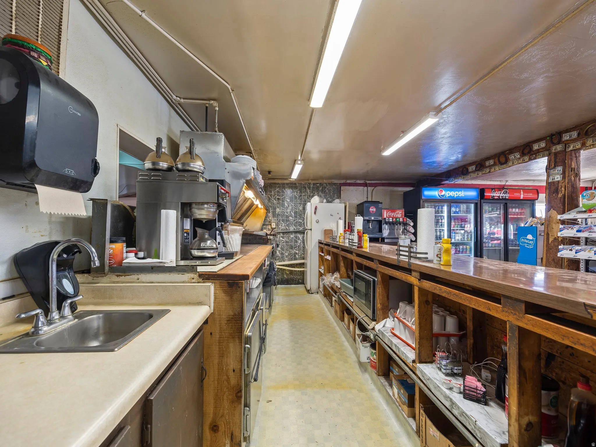 Kitchen with wooden counters, freestanding refrigerator, and stainless steel microwave