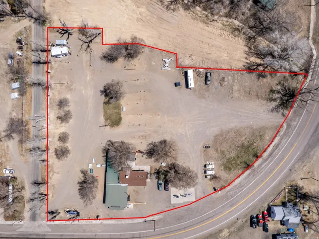 Aerial view of property and surrounding area featuring property parcel outlined