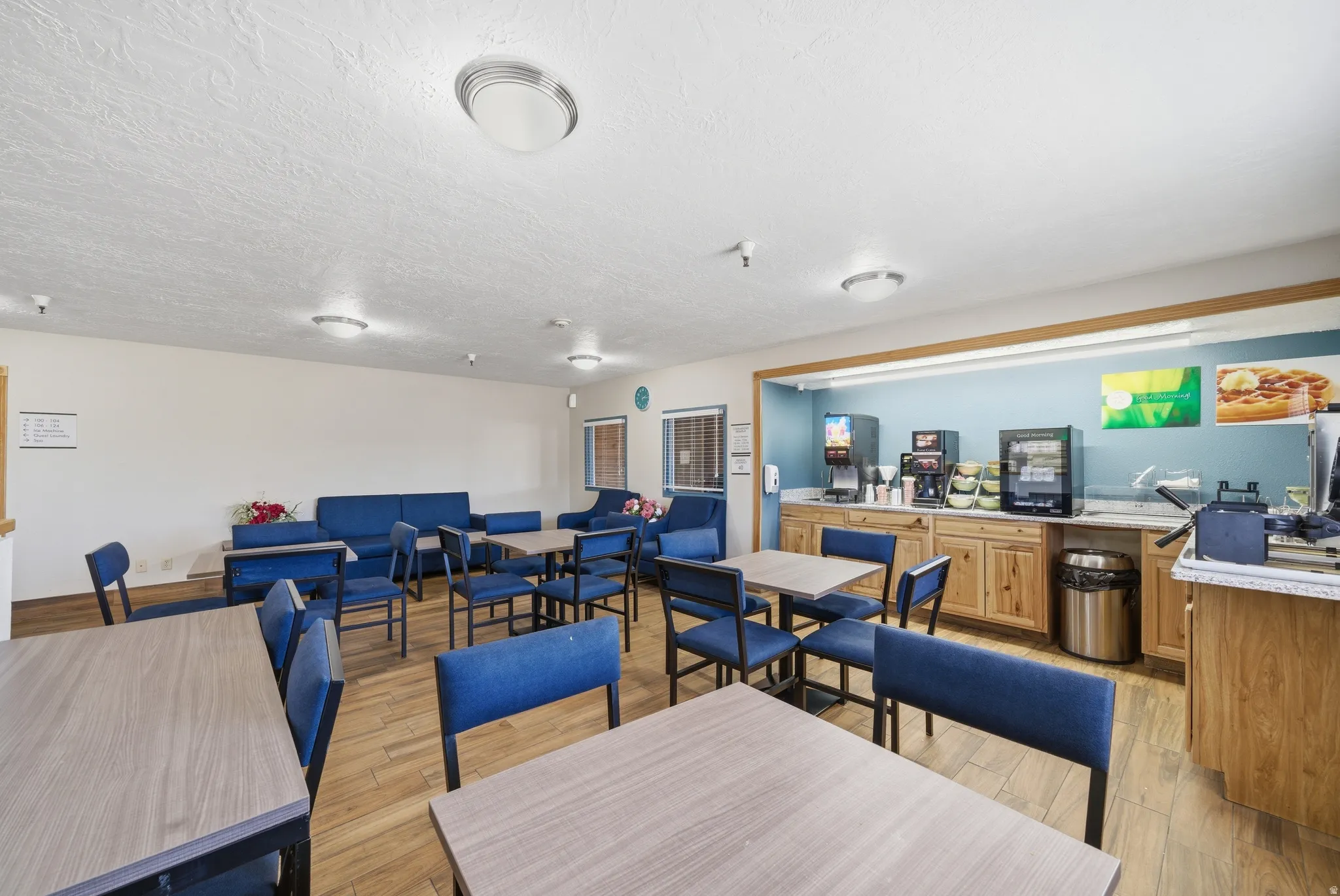 Dining area with light wood-style flooring and a textured ceiling