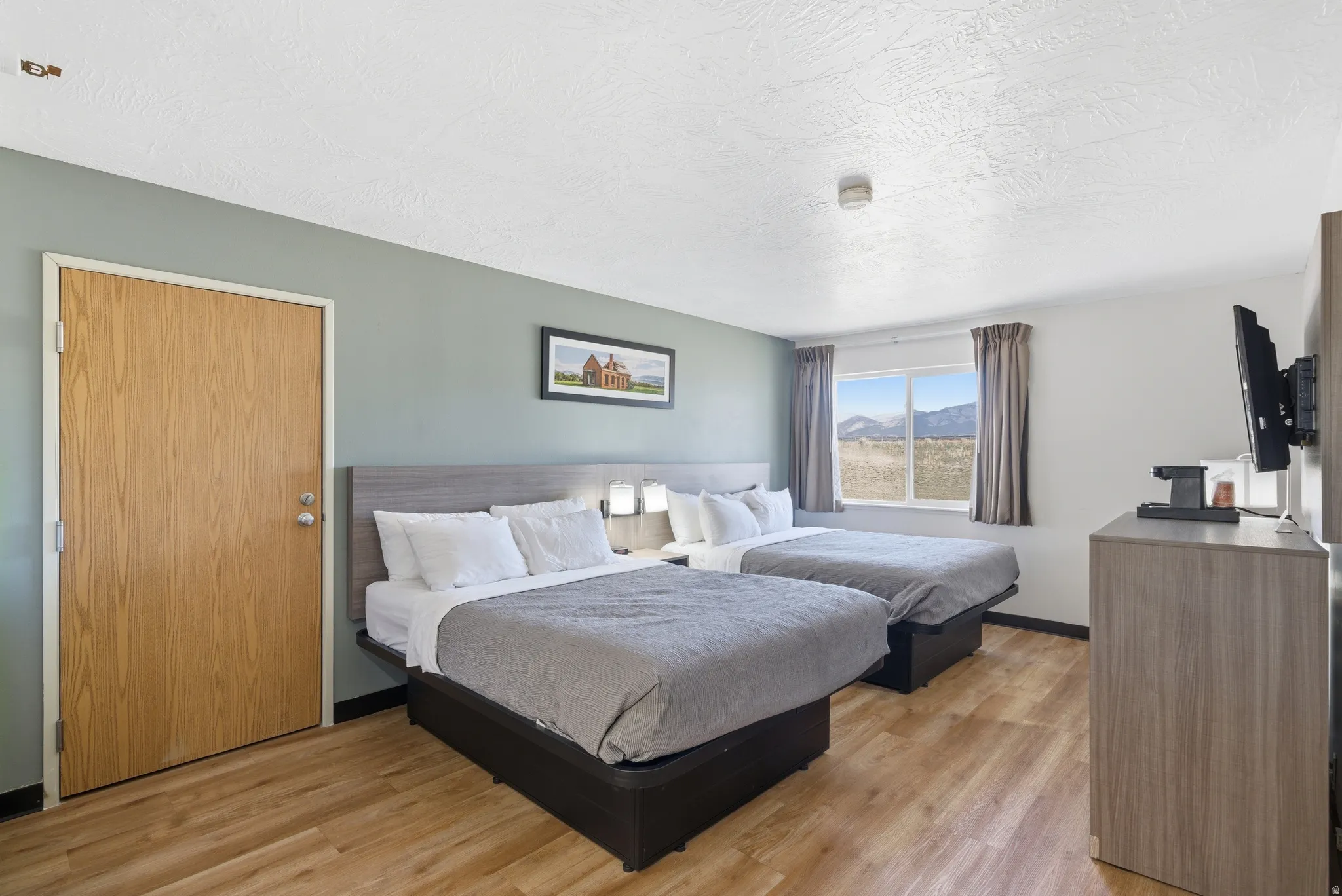Bedroom featuring light wood-style floors and a textured ceiling