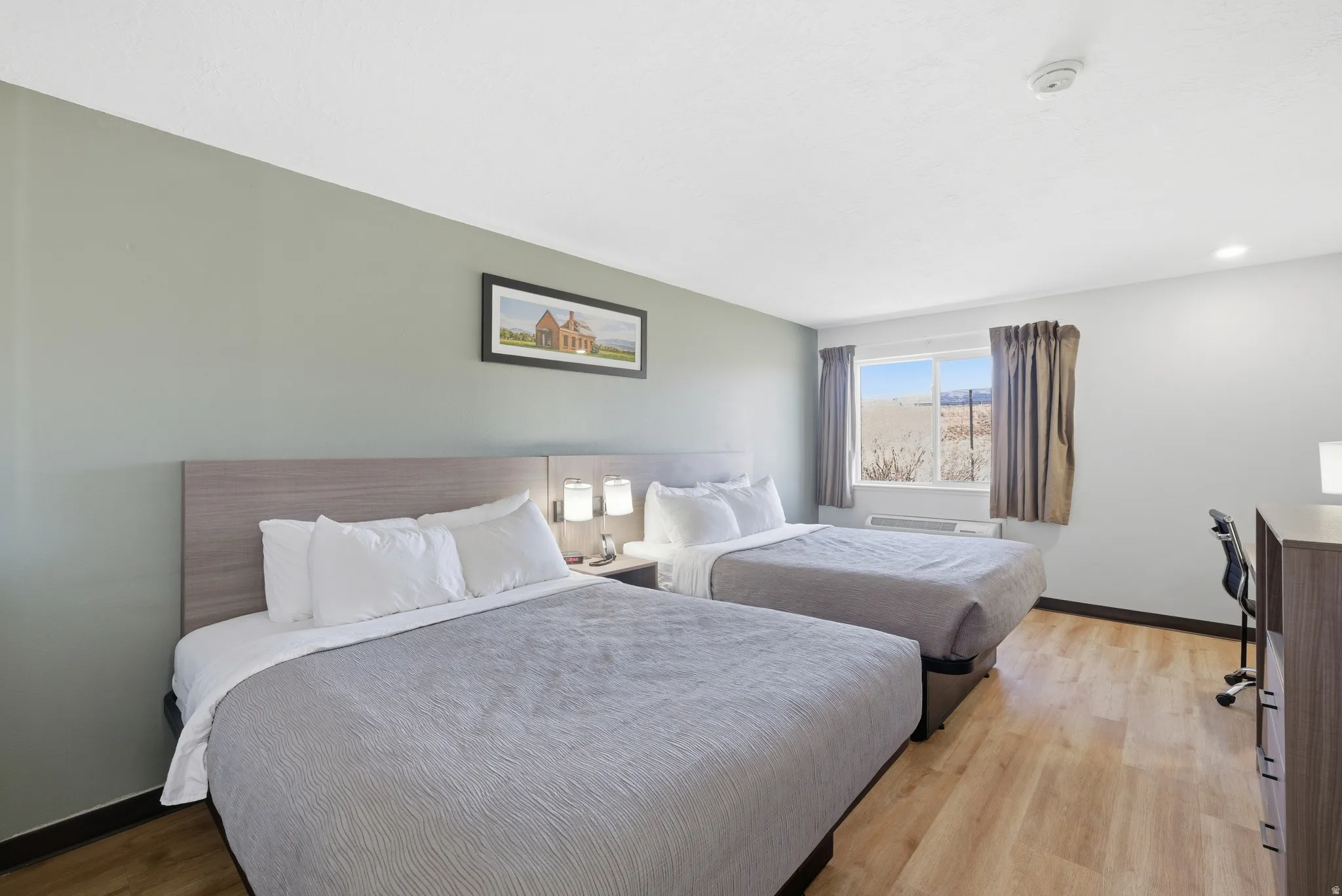 Bedroom with light wood finished floors and baseboards