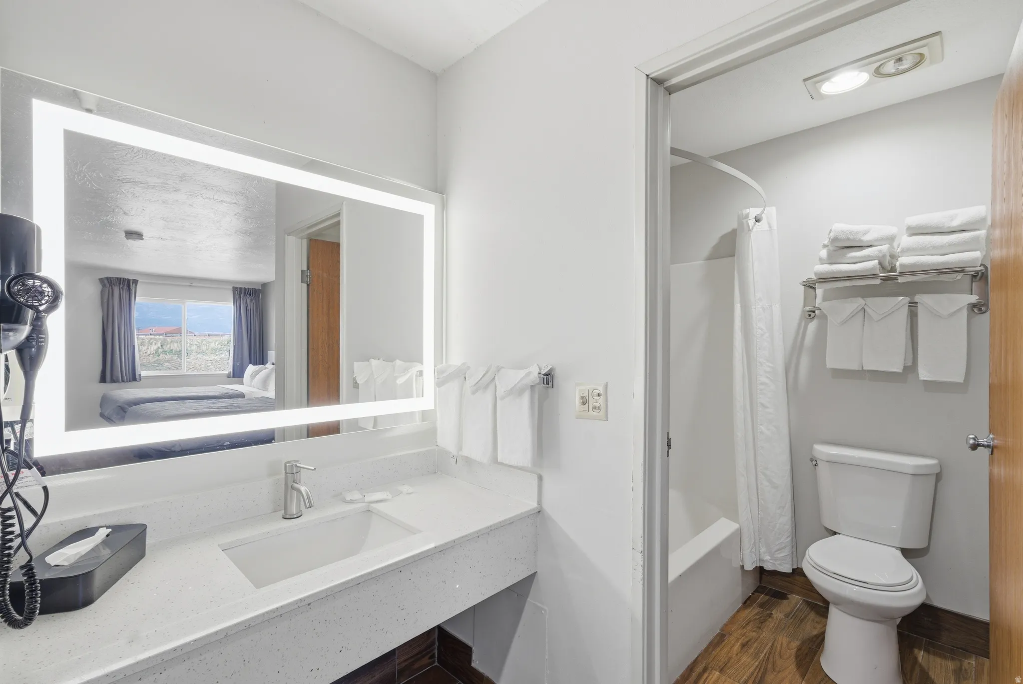 Full bathroom featuring vanity, dark wood-style flooring, ensuite bath, and shower / bathtub combination with curtain