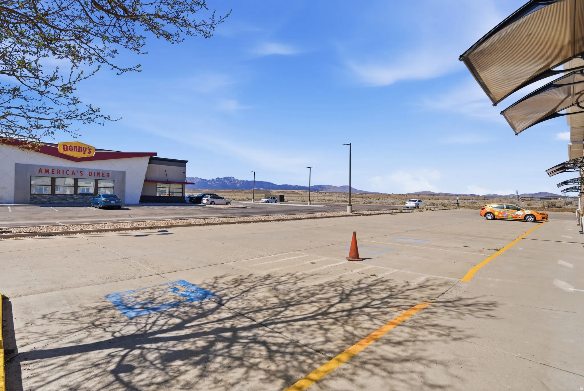 View of home's community with a mountain view and uncovered parking