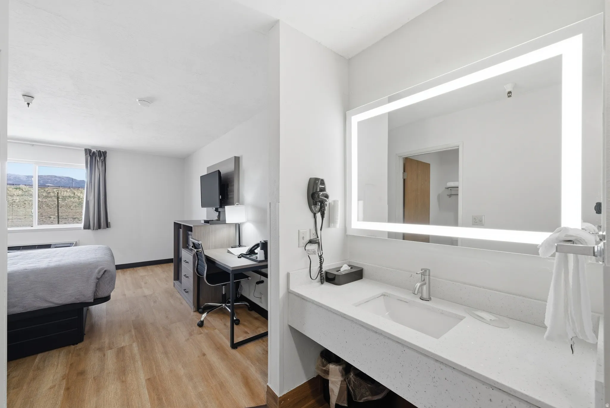 Bedroom featuring a desk and light wood-type flooring