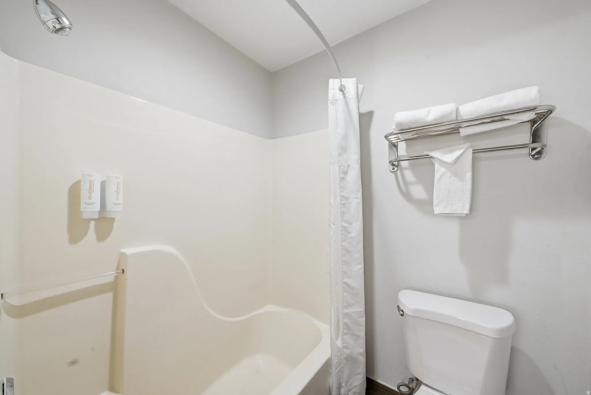 Full bath featuring toilet and shower / bath combo