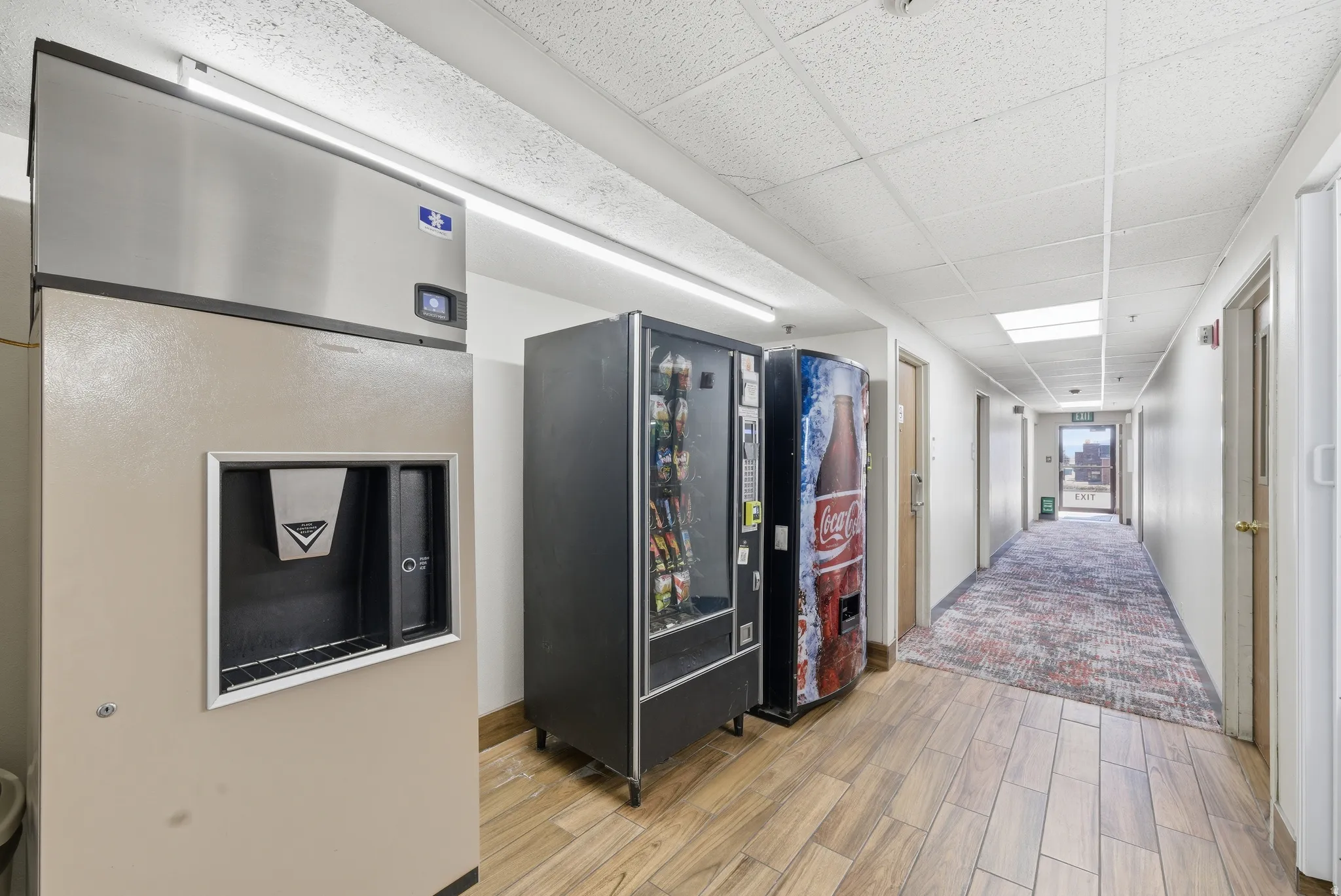 Hall with a paneled ceiling and wood finish floors