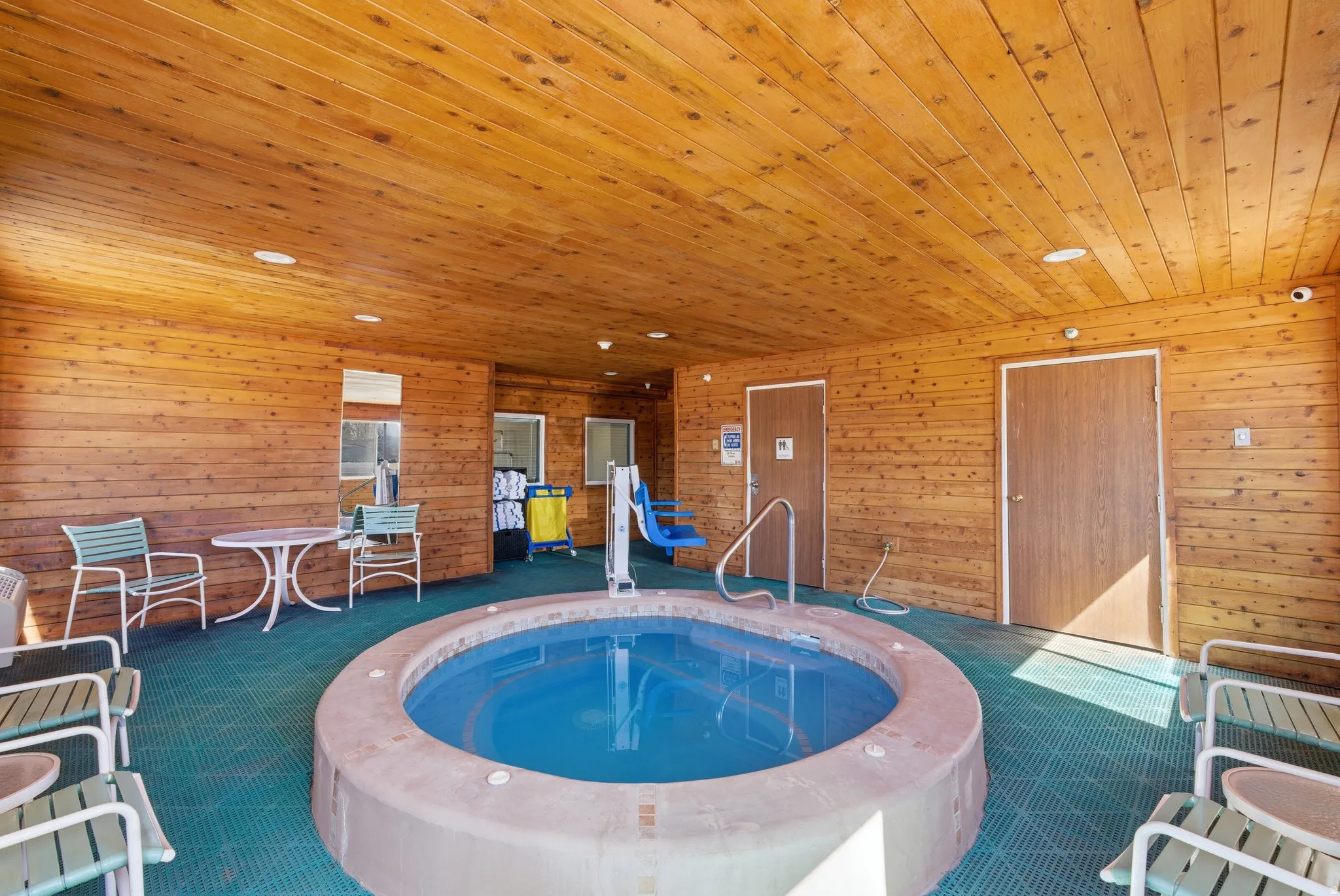View of swimming pool with an in-ground hot tub