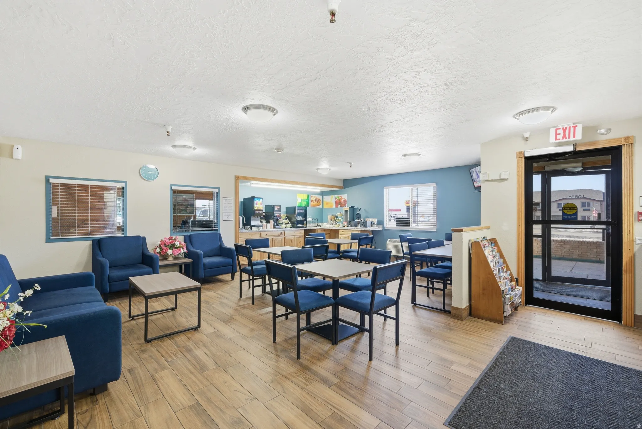 Dining room with light wood-type flooring and a textured ceiling
