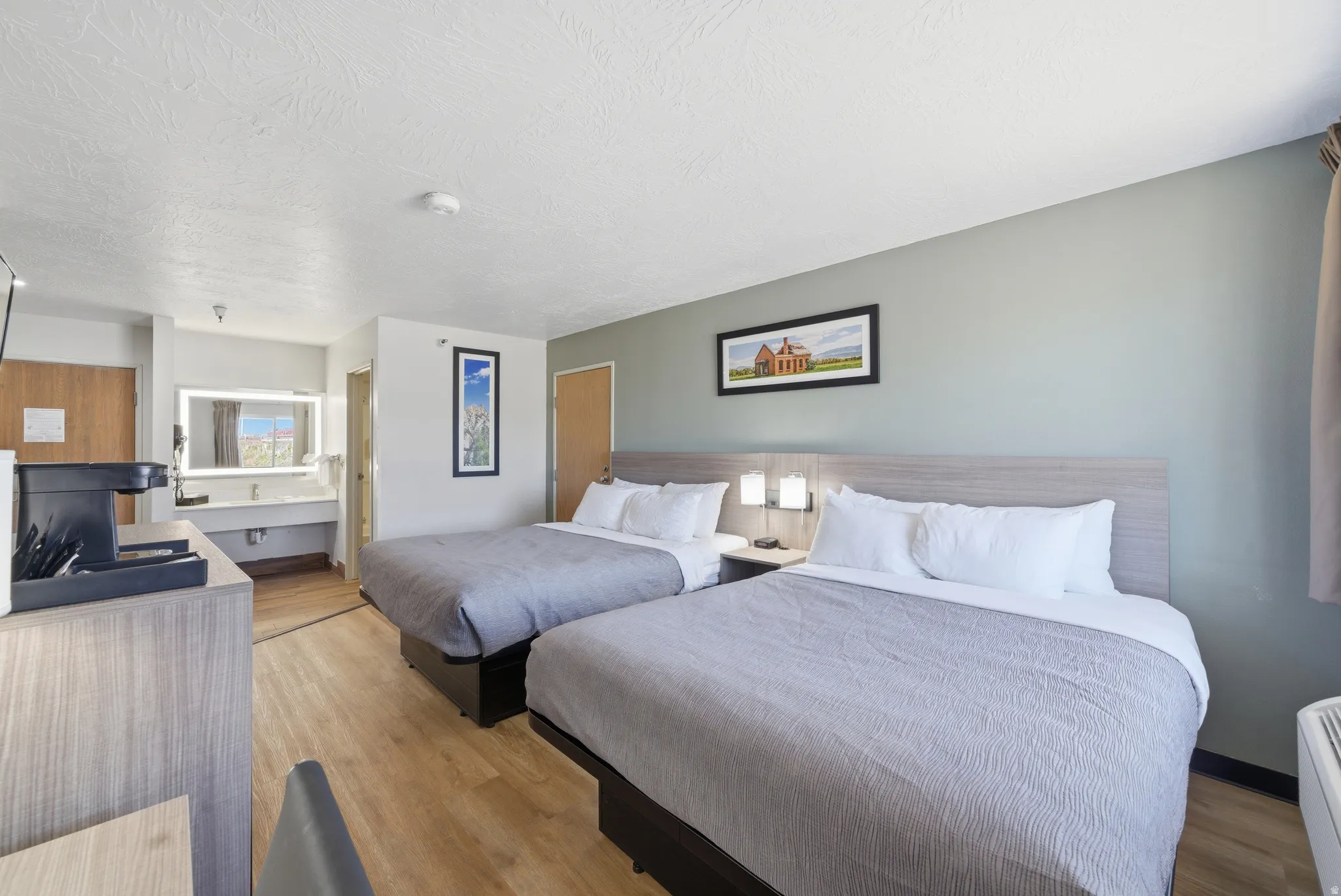 Bedroom with light wood-type flooring and a textured ceiling