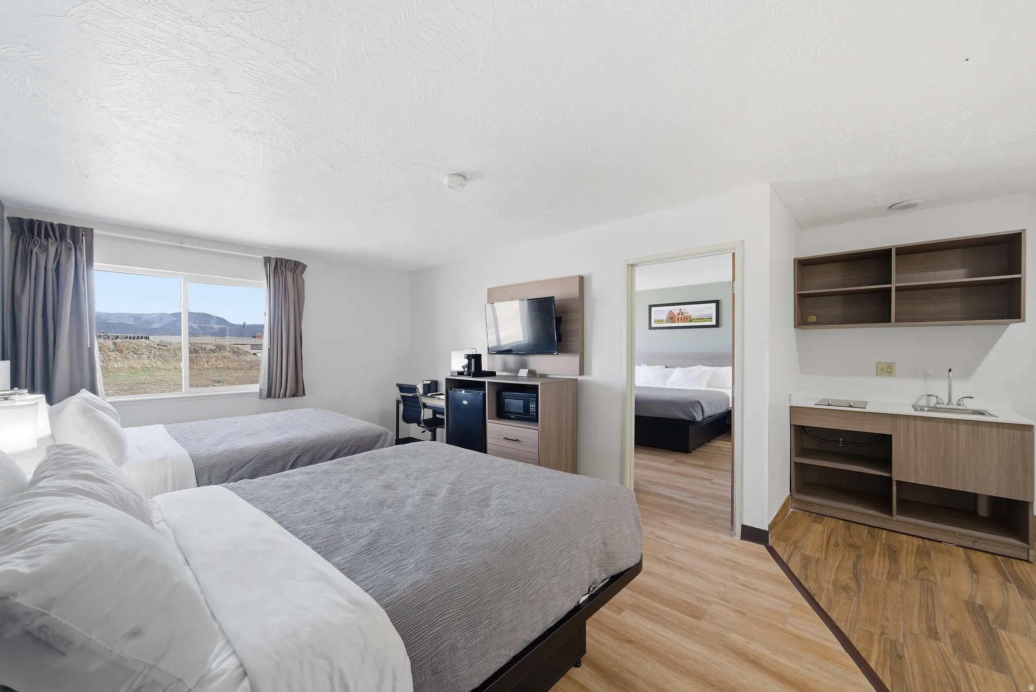 Bedroom featuring light wood-style floors and a sink