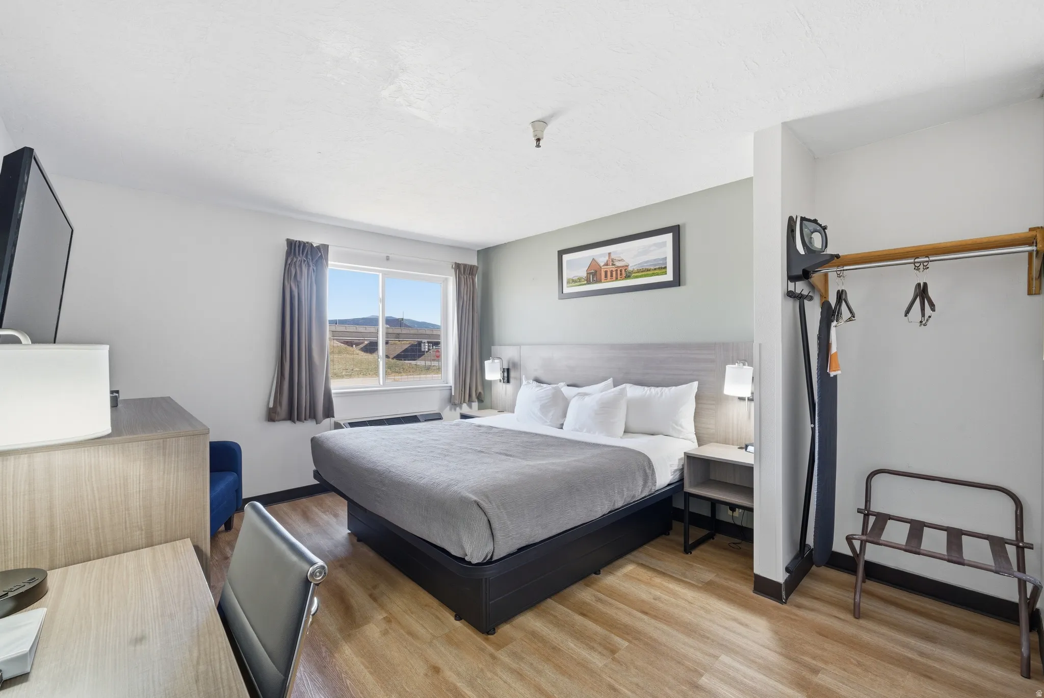 Bedroom featuring light wood finished floors and a mountain view