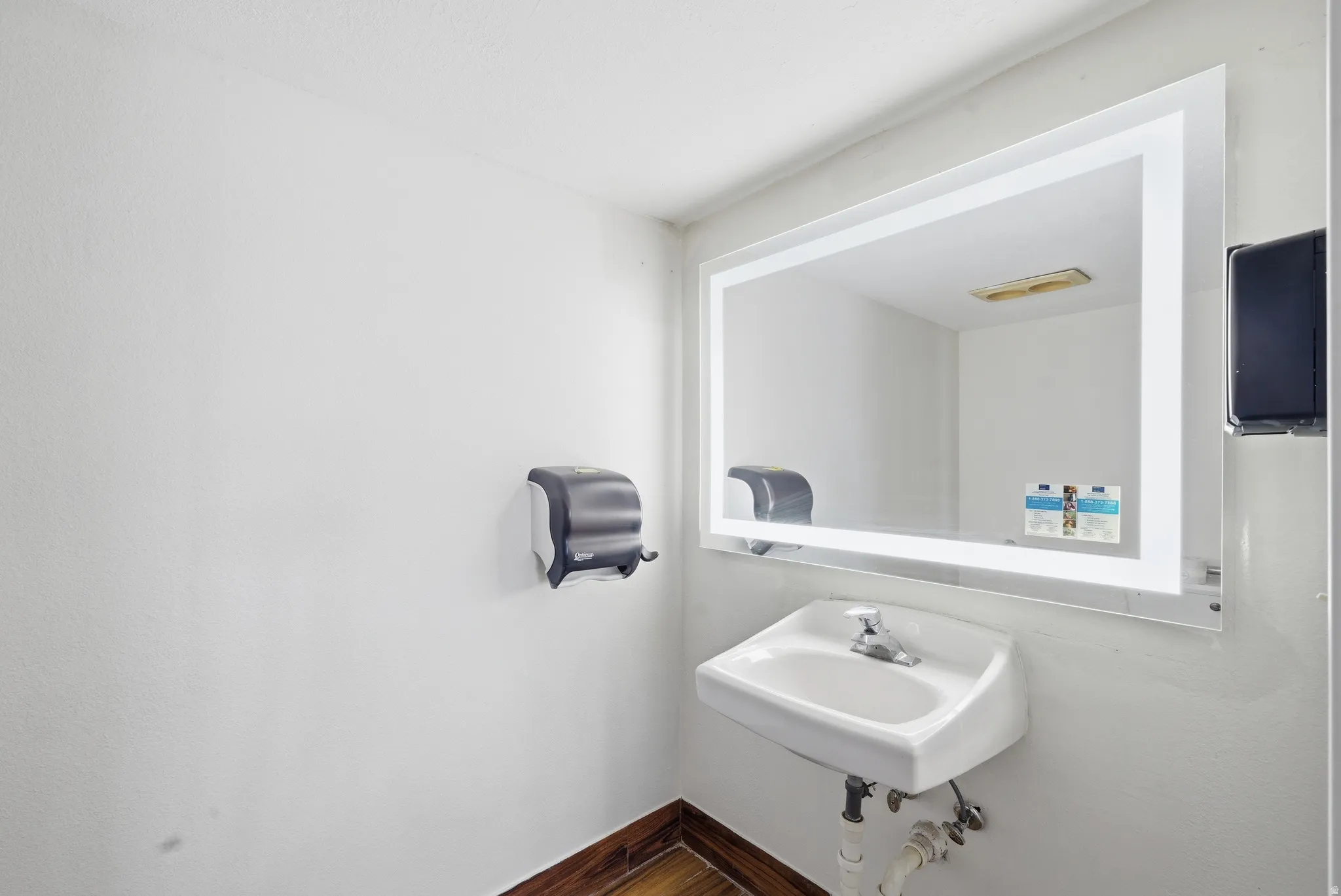 Bathroom featuring a sink and baseboards