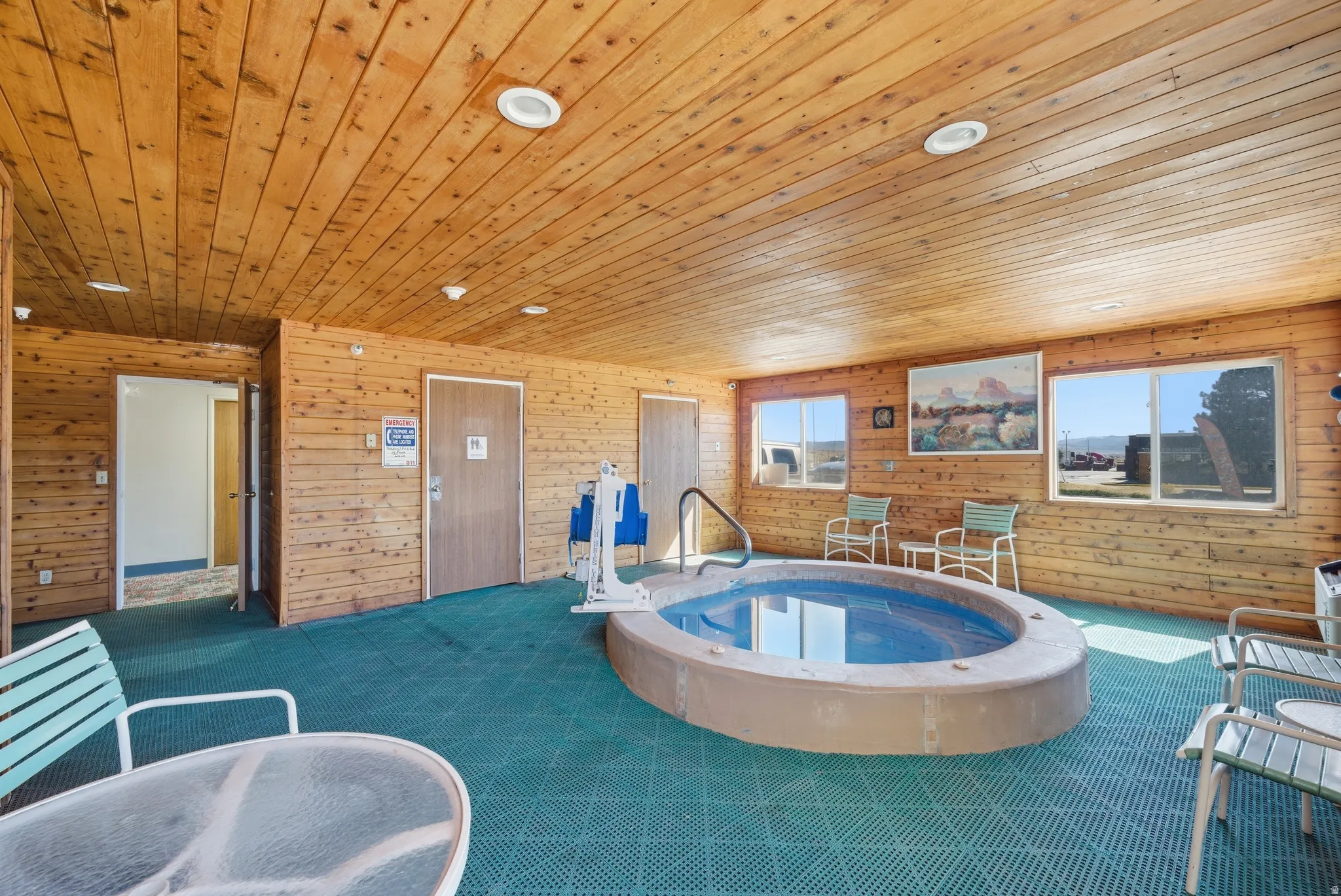 View of pool with an in-ground hot tub