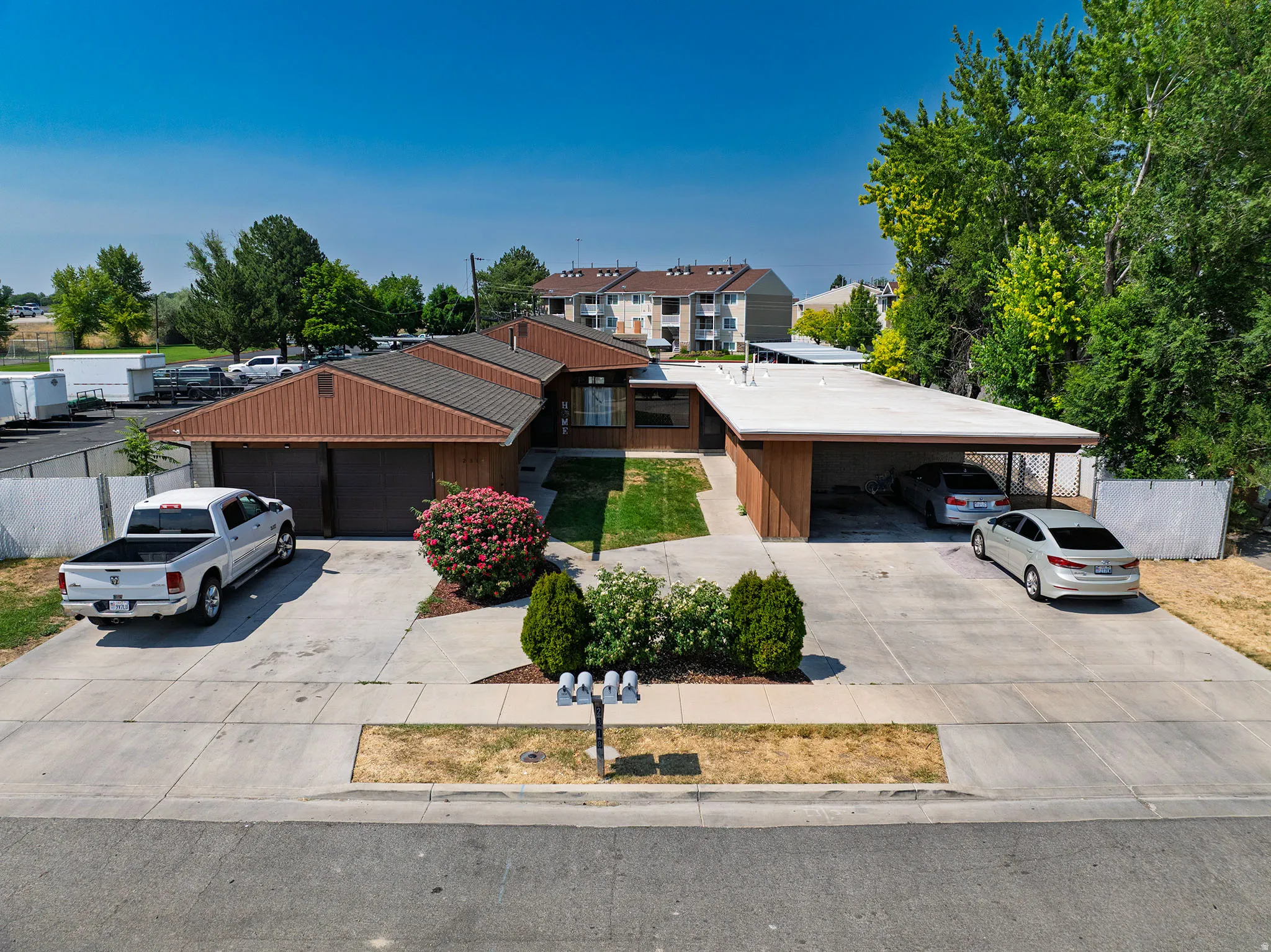 Mid-century modern exterior featuring wood siding and a brown shingle roof
