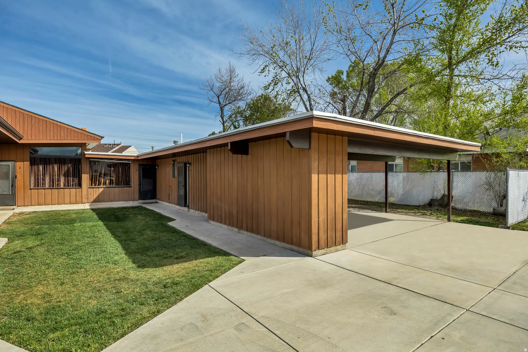 View of property exterior featuring concrete driveway