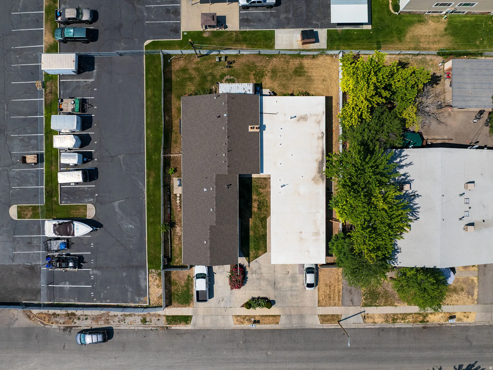 Aerial perspective highlighting two adjacent structures with distinct roofing materials
