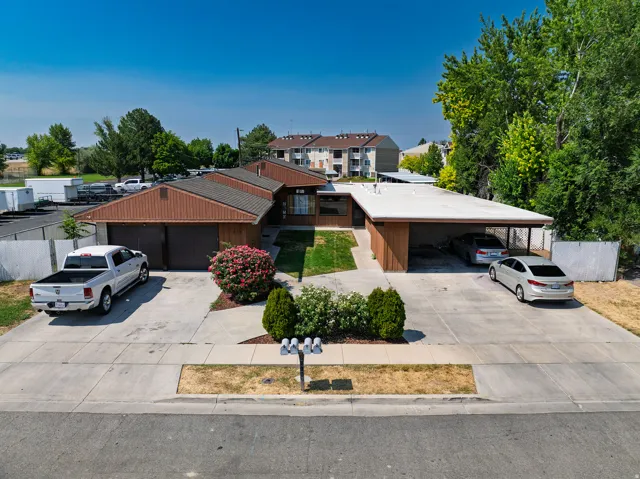 Mid-century modern exterior featuring wood siding and a brown shingle roof