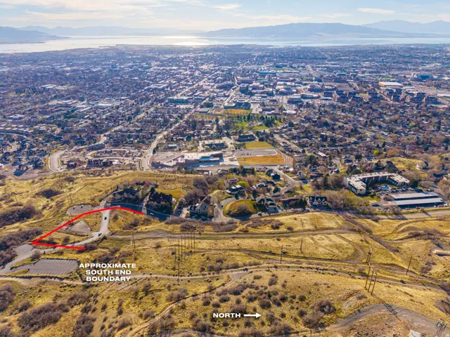 Aerial view of property and surrounding area with a mountainous background