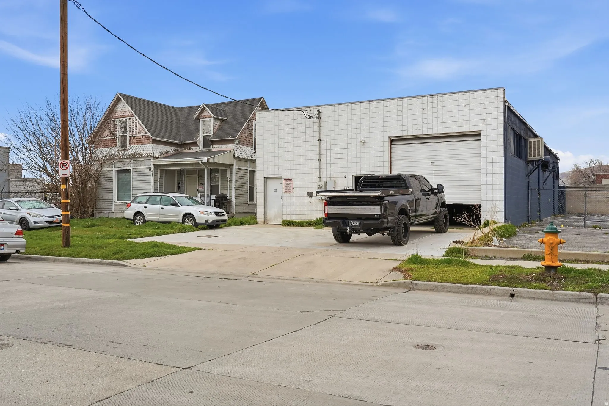 View of side of property featuring concrete driveway