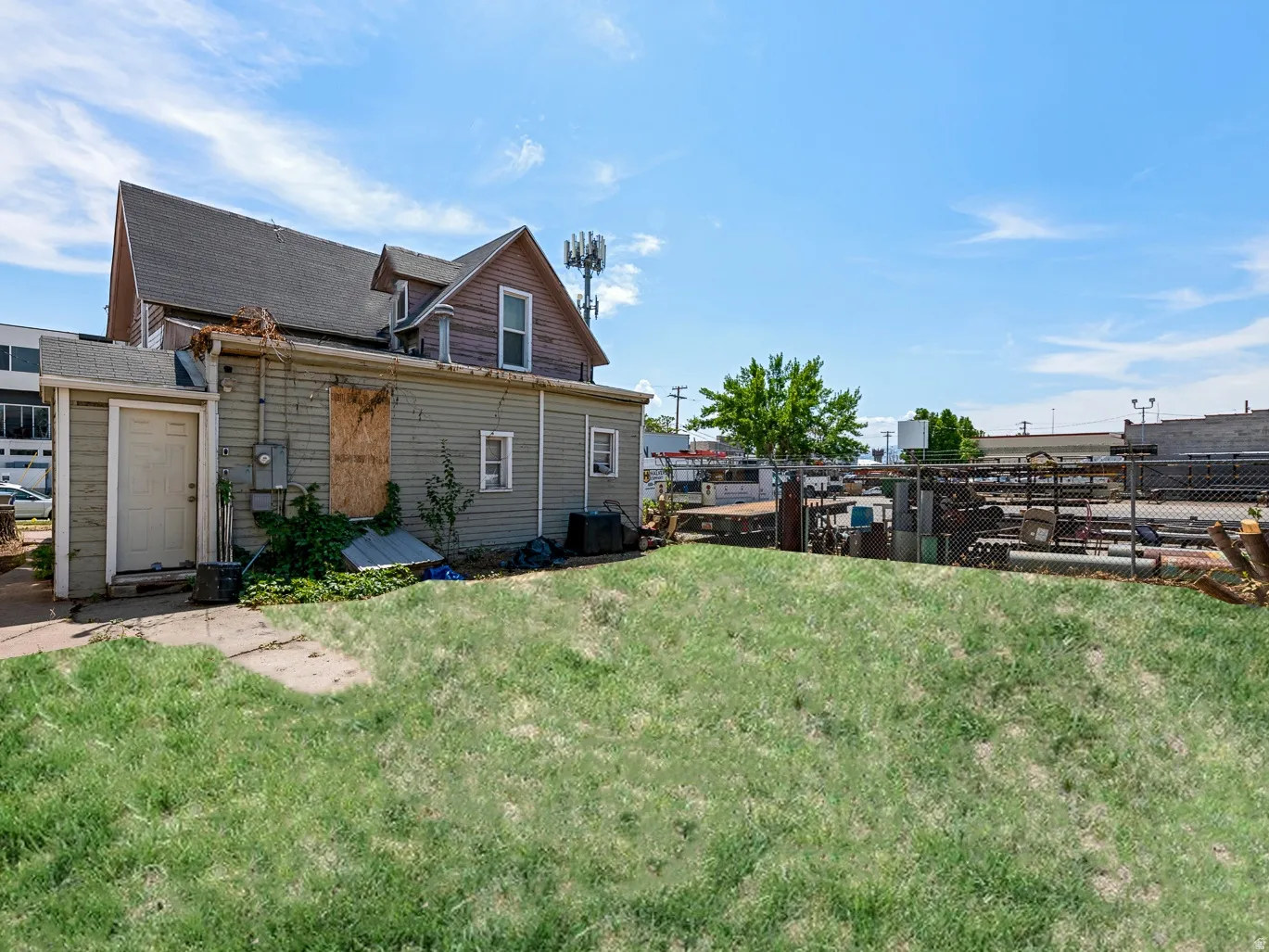 Back of property featuring a shingled roof