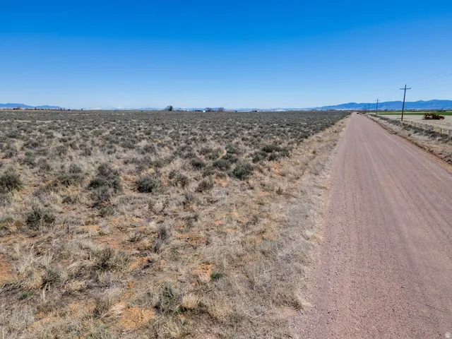 View of dirt / gravel road featuring a mountain view and a rural view