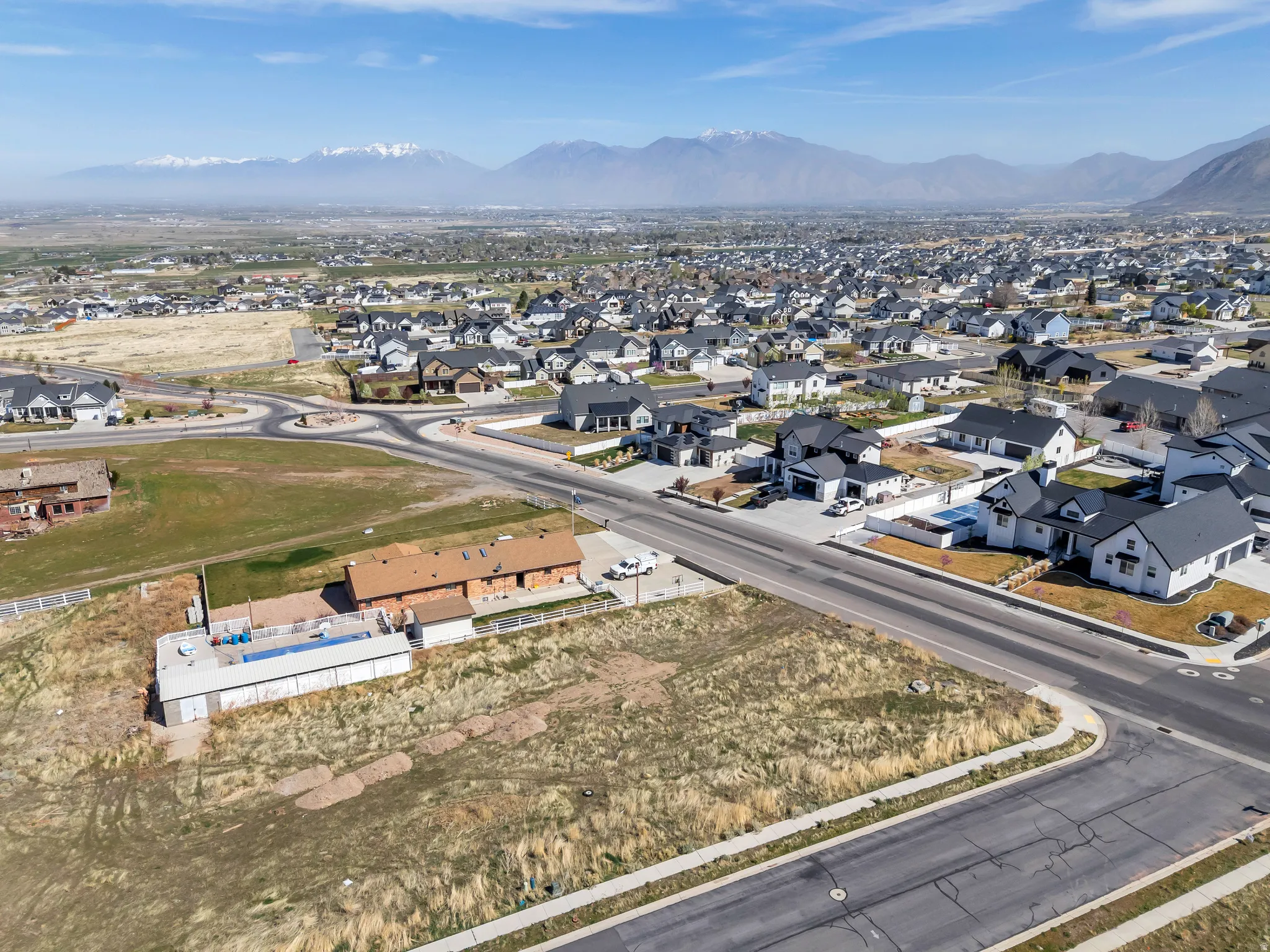Aerial overview of property's location featuring nearby suburban area and a mountainous background
