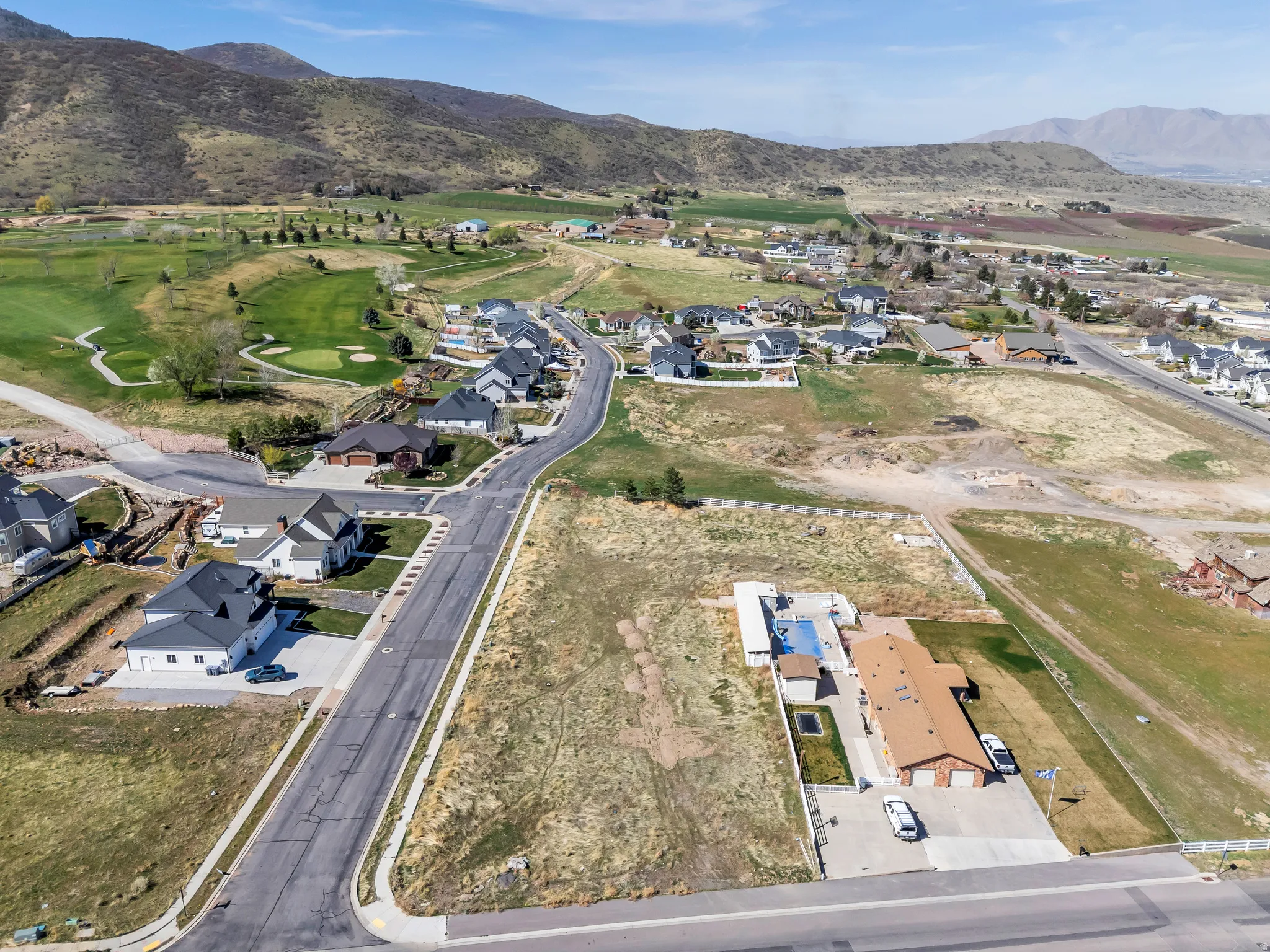 Aerial overview of property's location featuring nearby suburban area and mountains