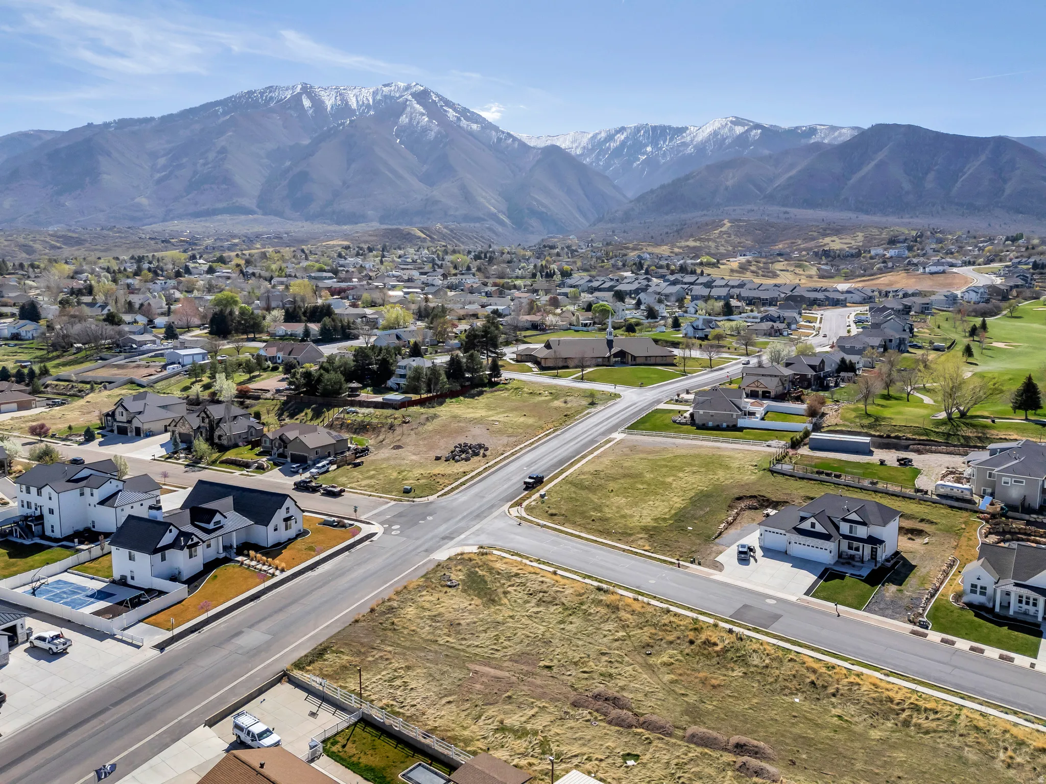 Aerial perspective of suburban area featuring a mountainous background