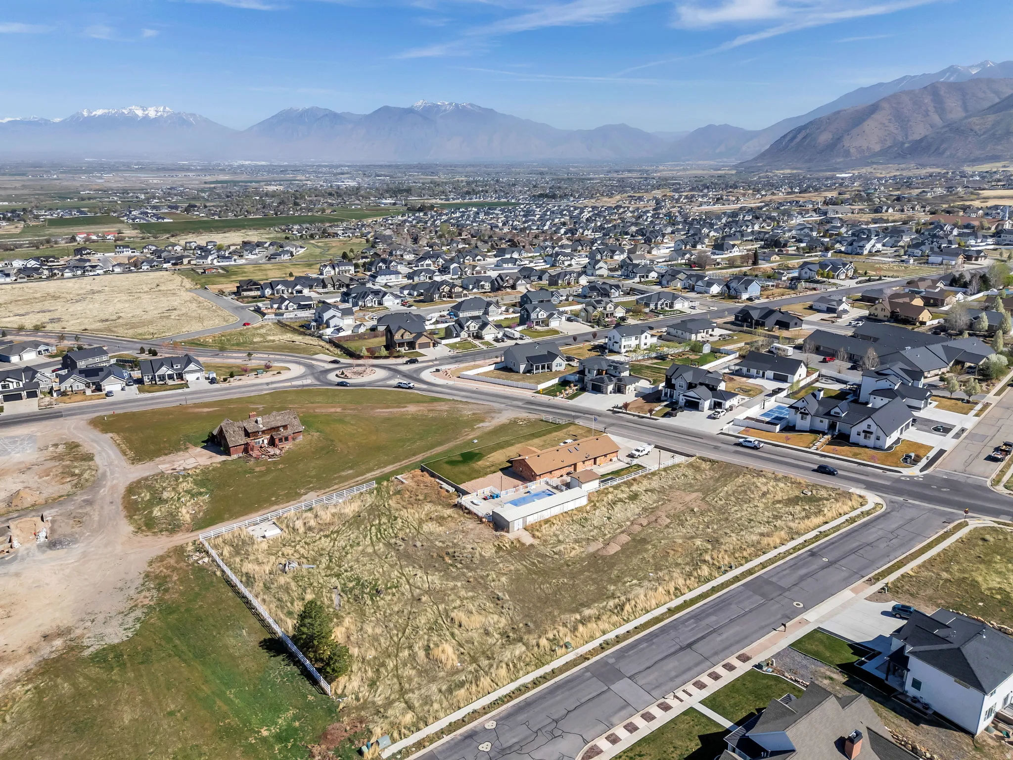 Aerial overview of property's location with nearby suburban area and a mountain backdrop
